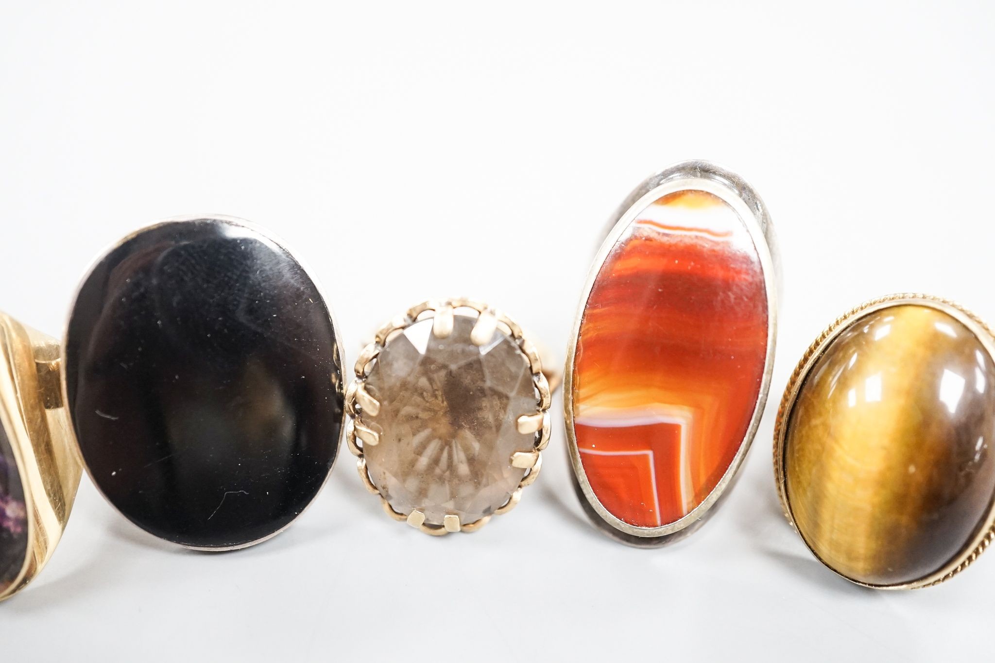 Three assorted 9ct gold and gem set dress rings, including blue john, smoky quartz and tiger's eye quartz, gross 23.9 grams and two white metal and hardstone set dress rings.